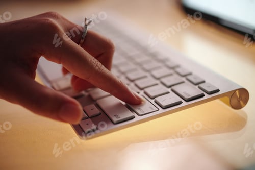 Preview: Typing on White Computer Keyboard at Office Desk
