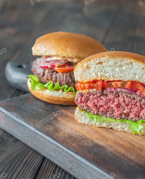 Preview: Two Delicious Burgers on Wooden Board