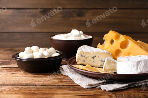 Preview: Composition with dairy products and clay dishware on wooden table