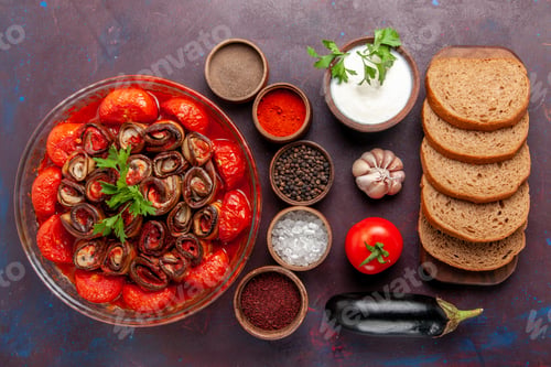 Preview: top view cooked vegetable meal tomatoes and eggplants with seasonings and bread on dark desk