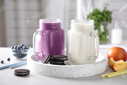 Preview: Tasty milk shakes in mason jars on tray