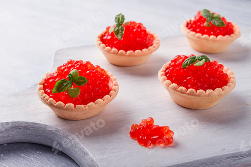 Preview: Tartlets with red caviar, on a light background, close-up, top view, no people,
