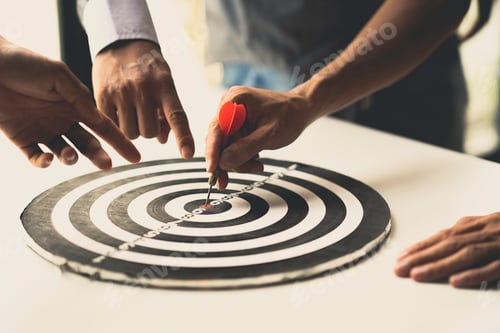 Preview: Three businessmen's hands pointing to a dart board to set goals for the future together successful b