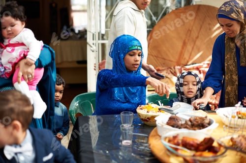Preview: Food brings everyone together. Shot of a muslim family eating together.