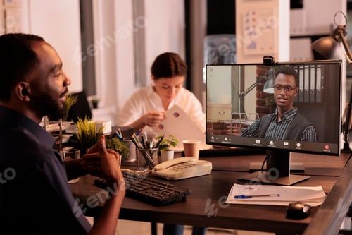 Preview: Remote coworkers talking on corporate videocall on computer