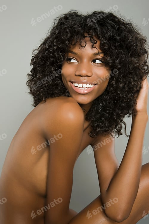 Preview: Joyful woman with a radiant smile posing against a grey background