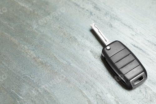 Preview: Car key on grey background. Space for text