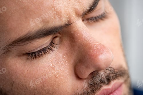 Preview: close up of man with sweaty face suffering from heat with closed eyes on grey