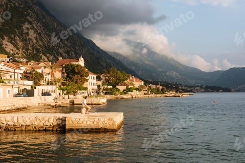 Preview: Young man standing on pier looking away, Kotor, Montenegro, Europe