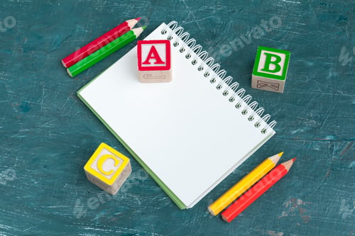 Preview: Notepad on wooden table and wood alphabet blocks