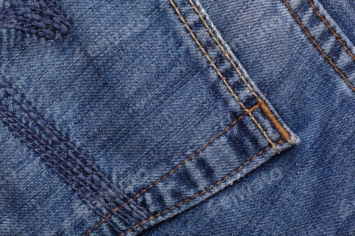 Preview: Denim Jeans Texture Background With Torn. The Texture Of The Colored Cotton Fabric. Stitched
