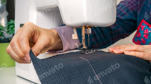 Preview: Seamstress hands working on a sewing machine