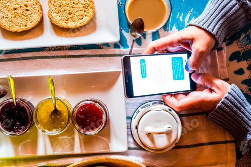 Preview: Above close up view of phone connection during breakfast