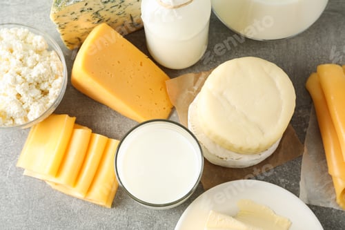 Preview: Different dairy products on grey background, top view