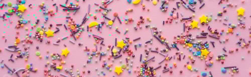 Preview: Top view of different sprinkles on pink background, banner