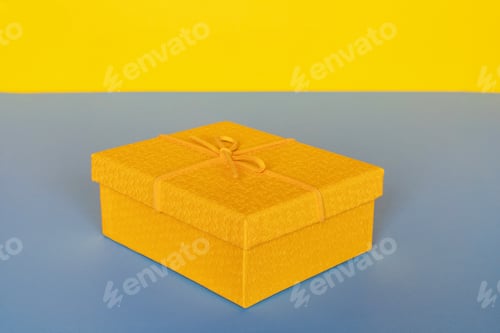 Preview: Yellow gift box on blue background with copy space