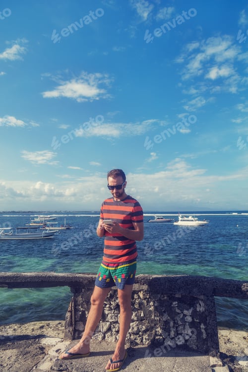 Preview: Young Man Using Cellphone / Smartphone Near Ocean.