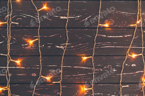 Preview: Christmas garland on wooden background with copy space