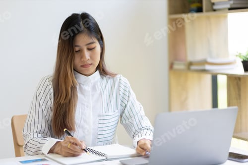 Preview: Businesswoman in the office working on business financial reports.