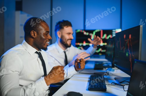 Preview: This is success. Two happy traders or financial analysts in the office celebrating a winning deal