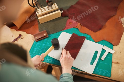 Preview: Unrecognizable Craftsman Punching Holes