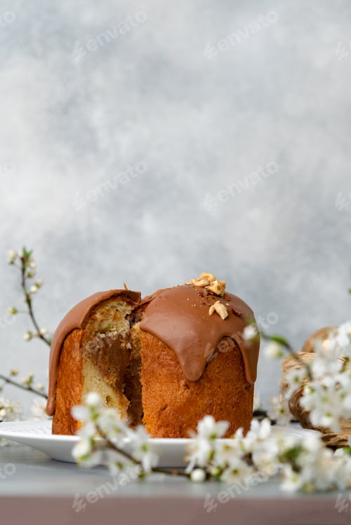 Preview: Cut Easter cake on plate decorated with spring flower branches