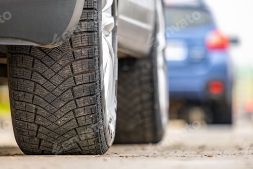 Preview: Closeup of parked car on a city street side with new winter rubber tires