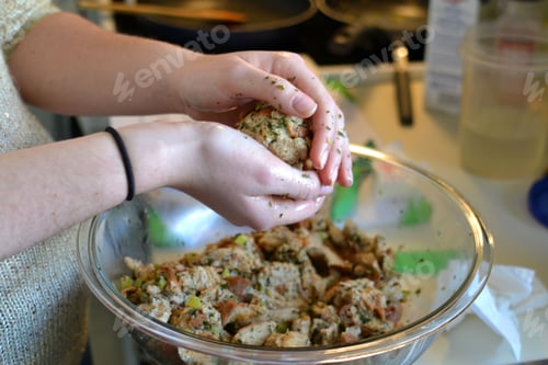 Preview: Cooking Thanksgiving dinner in the kitchen. A girl using her hands to form make dressing balls.