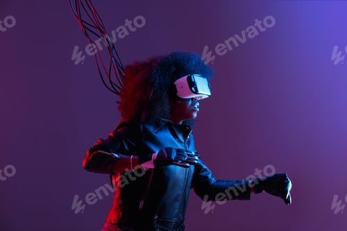 Preview: Mod curly dark haired girl dressed in black leather jacket and gloves uses the virtual reality