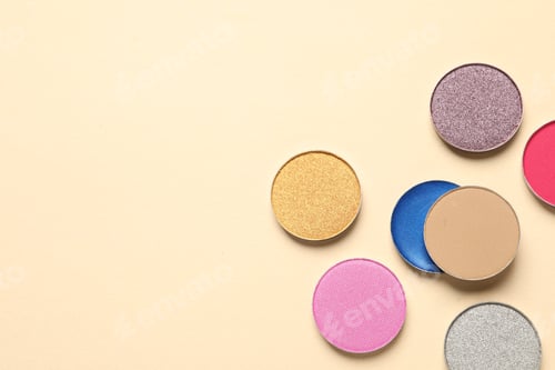 Preview: Different beautiful eye shadows on beige background, flat lay. Space for text
