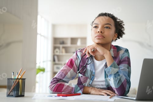 Preview: Teenage afro girl is bored at online lesson. Remote study at high school or college at home.
