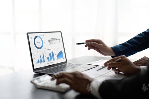 Preview: Two male accountants use calculator to calculate the company financial results with on data network