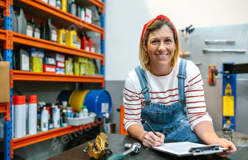 Preview: Woman checking stock in mechanic workshop