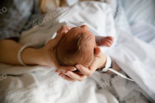 Preview: Mom holding her newborn baby at the hospital