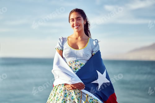 Preview: latin woman holding over the shoulders a flag of Chile wearing national costume