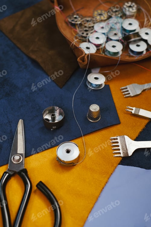 Preview: Tailor workplace. Close up view of the eco leather and tailoring equipment