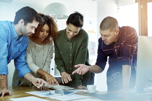 Preview: Cropped shot of a group of coworkers discussing something on a tablet