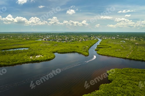 Preview: Aerial view of Florida wetlands with green vegetation between ocean water inlets.