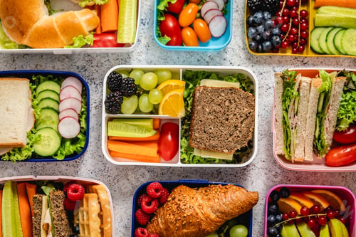Preview: Shot of school lunchboxes with various healthy nutritious meals on stone background