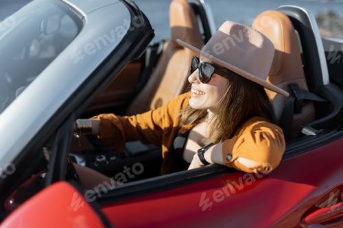 Preview: Woman driving a cabriolet near the ocean