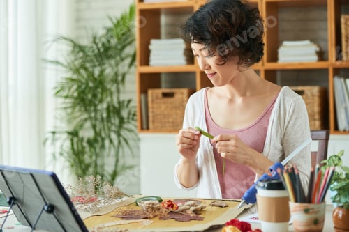 Preview: Woman Attaching Dried Flowers to Canvas