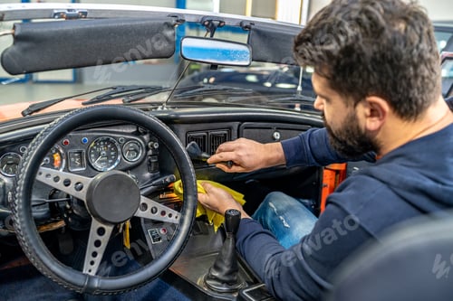 Preview: cleaning the interior of the old car with a brush and rag