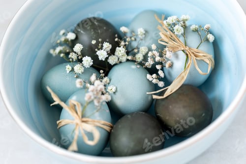 Preview: Colored Easter eggs in a bowl, closeup. Festive decoration.