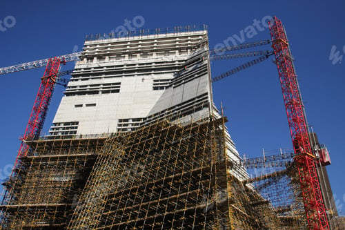 Preview: Construction cranes with scaffolding on a high-rise site