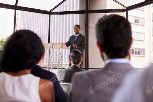 Preview: Black businessman presenting business seminar to an audience