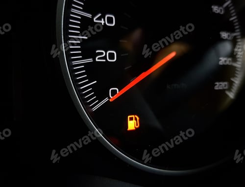 Preview: Close-up image of Low fuel lamp on dashboard in car.