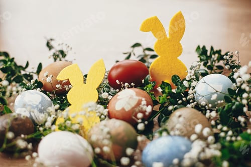 Preview: Stylish easter eggs and yellow bunny on rustic wooden table