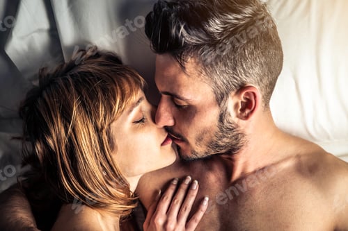 Preview: Romantic couple kissing lying on bed