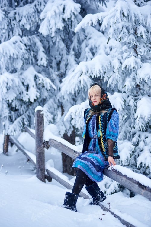 Preview: Young woman in blue dress, embroidered warm sleeveless fur coat and kerchief with floral design.