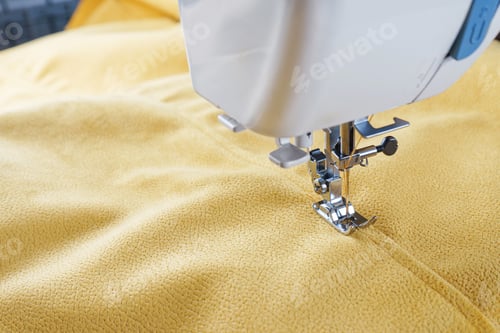 Preview: Modern Sewing Machine With Yellow Velours Fabric Close Up